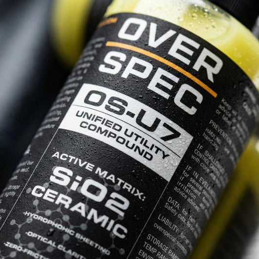 Bottle labeled 'OVER SPEC OS-U7 Unified Utility Compound' with technical text on a black background.
